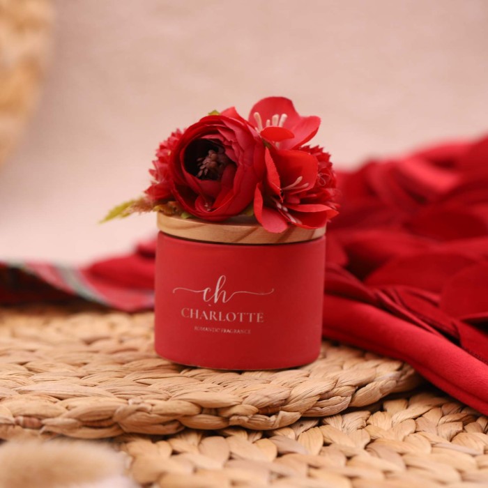 Portacandele in porcellana rossa con marchio Charlotte sul fronte e fiori rossi